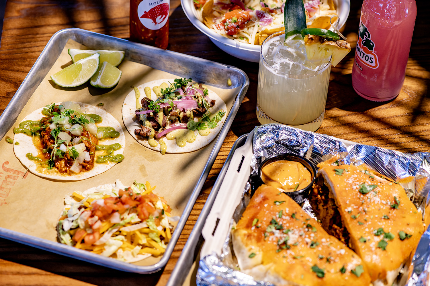 Juntos tacos and golden quesadillas arranged on a table